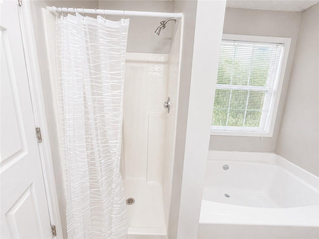 6936 Red Bone Way Stonecrest, GA 30038 - Photo 13 of 17 a bathroom with a bathtub and shower