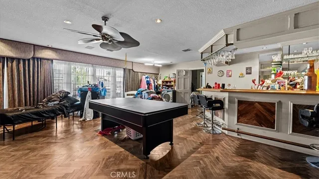 a living room with lots of furniture and kitchen view