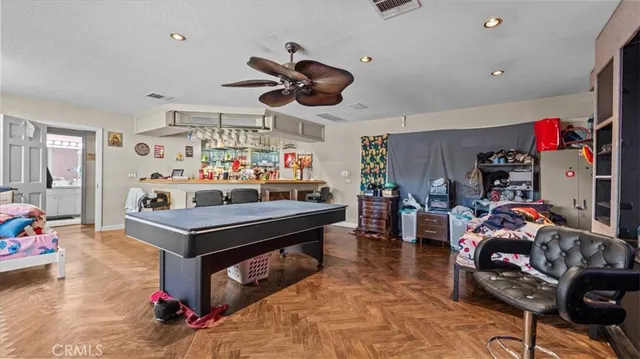 a view of a play room with furniture and toys