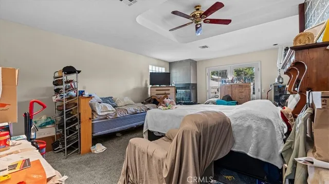 a bedroom with furniture and a flat screen tv