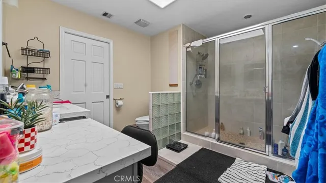 a bathroom with a tub shower and mirror