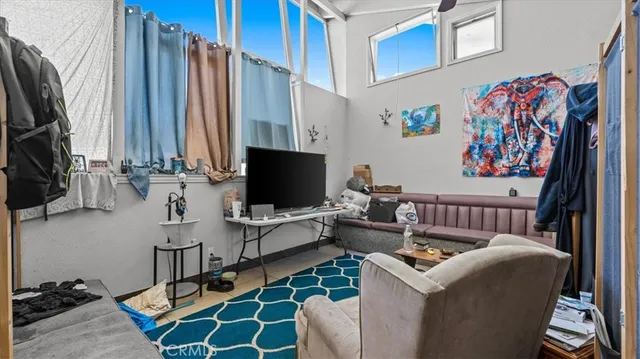 a view of a workspace with furniture and a flat screen tv