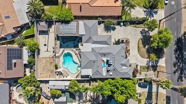 an aerial view of a house with a garden and swimming pool