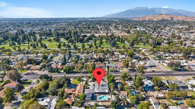 an aerial view of residential houses with outdoor space and swimming pool