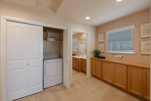 a room with a chair and a refrigerator