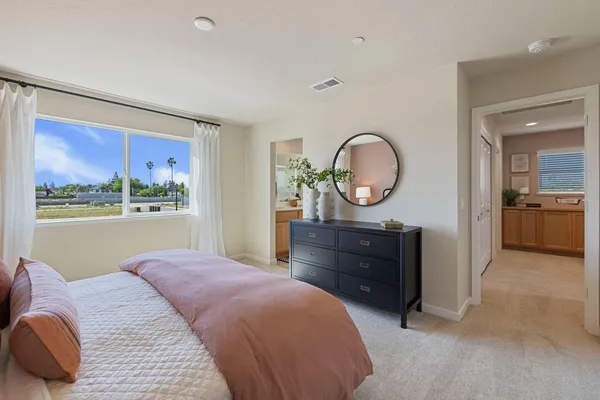 a bedroom with a bed and a painting on the wall