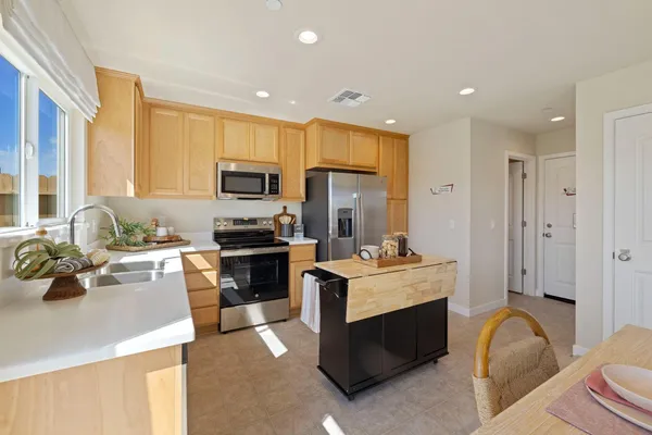 a kitchen with a sink stove and refrigerator