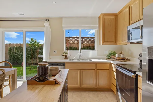 a kitchen with a sink stove and cabinets