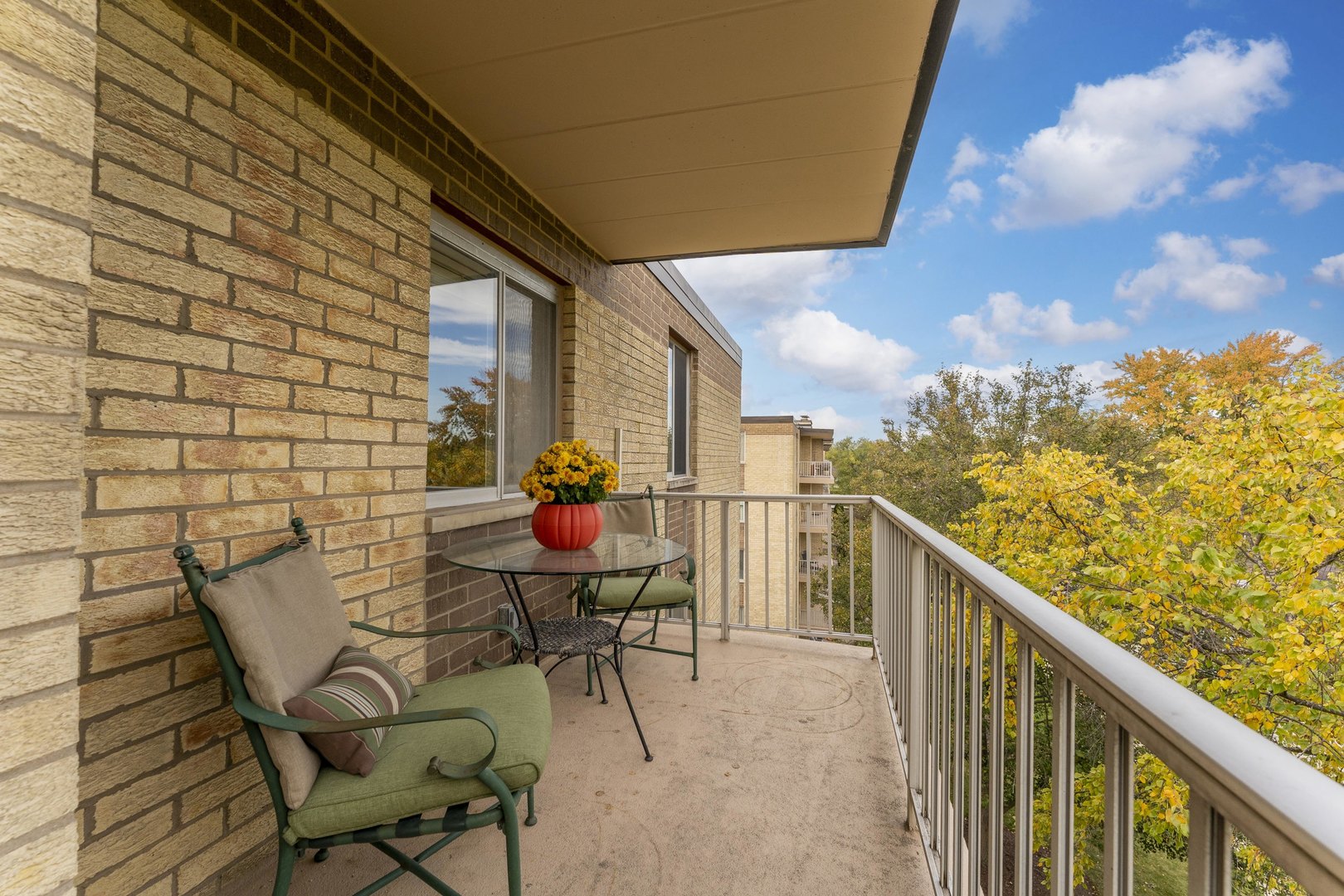 110 West Butterfield Road, Unit 502S Elmhurst, IL 60126 - Photo 19 of 31 a view of a chairs and table in patio with wooden fence