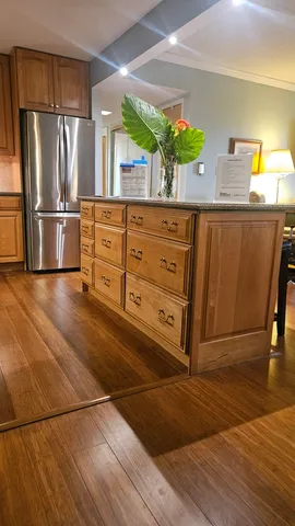 a kitchen with granite countertop a refrigerator and a sink