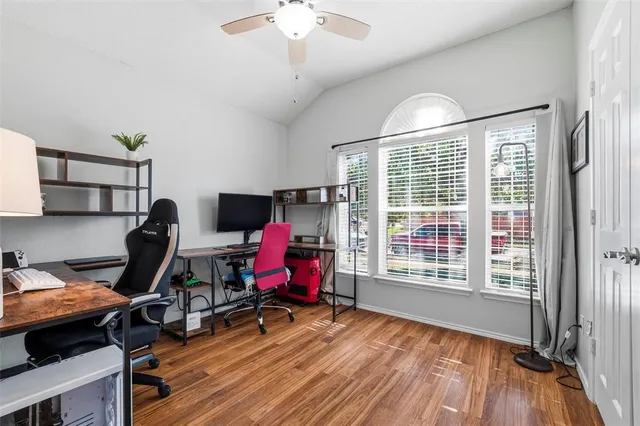 a view of a workspace with furniture and a window
