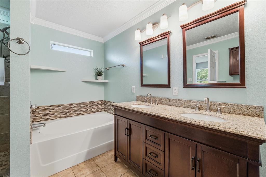 5104 Valley Village Drive Fort Worth, TX 76123 - Photo 21 of 28 a bathroom with a sink a vanity and a mirror