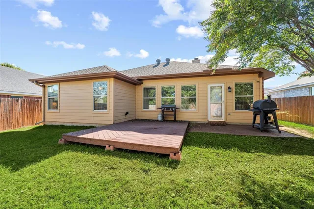 a view of a house with a backyard and a patio