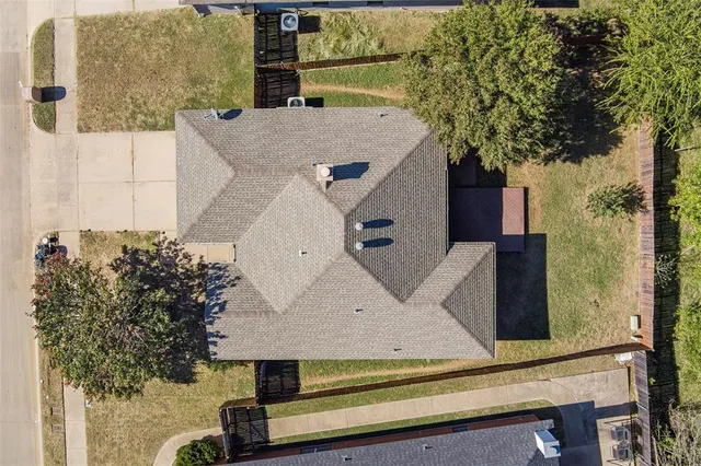 an aerial view of a house with a yard
