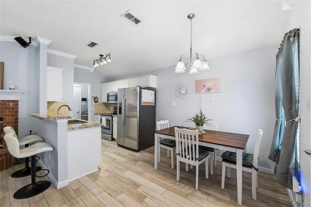 a view of a dining room with furniture and a chandelier