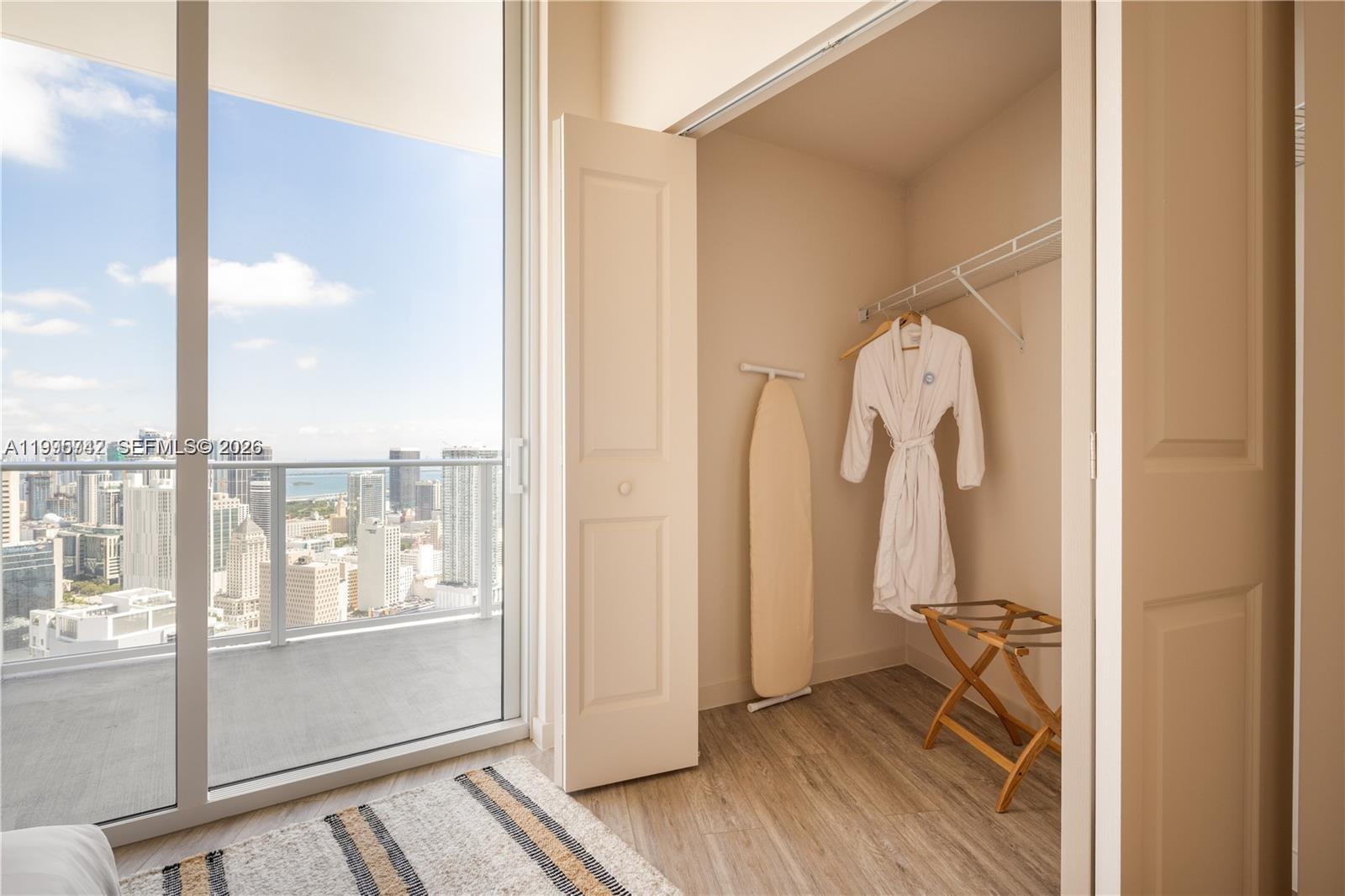 275 Southwest 6th Street, Unit 806 Miami, FL 33130 - Photo 9 of 24 a view of walk in closet with clothes and shoes