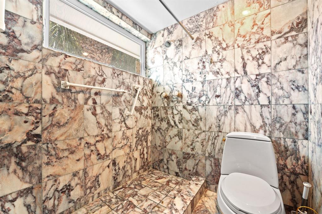 4620 Northeast 25th Avenue Fort Lauderdale, FL 33308 - Photo 21 of 30 a bathroom with a toilet and a shower curtain