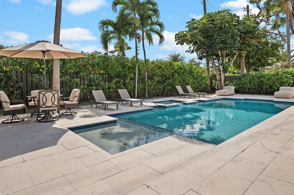 4620 Northeast 25th Avenue Fort Lauderdale, FL 33308 - Photo 4 of 30 a view of a swimming pool with lawn chairs under an umbrella
