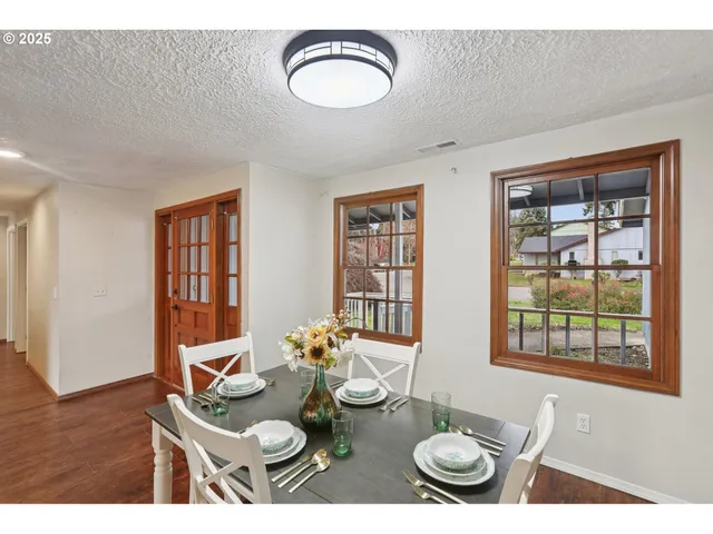 a dining room with furniture and window