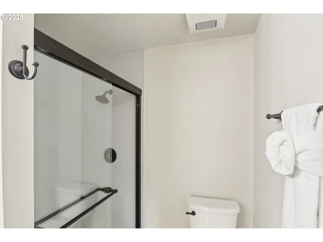 a bathroom with a shower and mirror