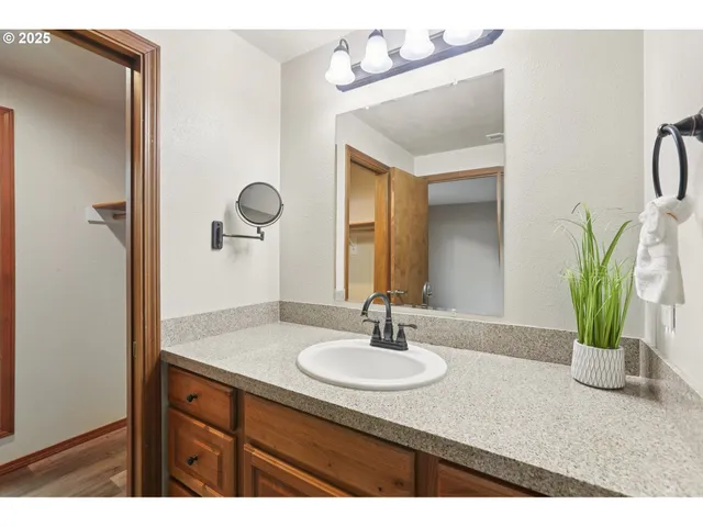 a bathroom with a sink vanity and a mirror