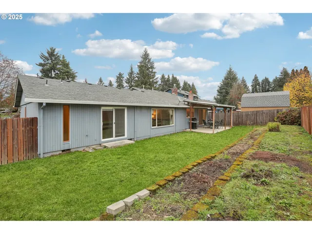 a view of a backyard with wooden fence
