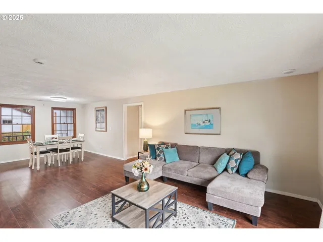a living room with furniture and wooden floor
