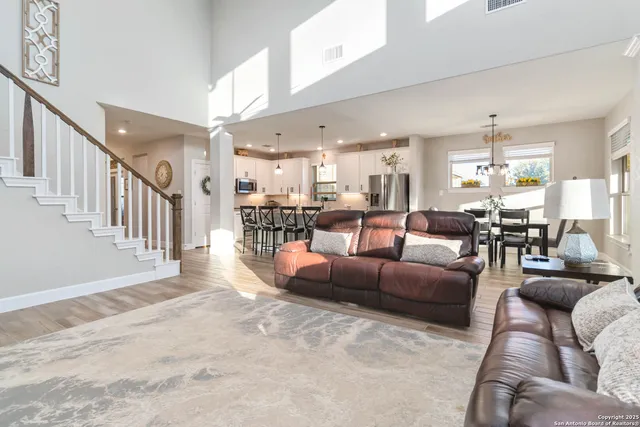 a living room with furniture and a dining table