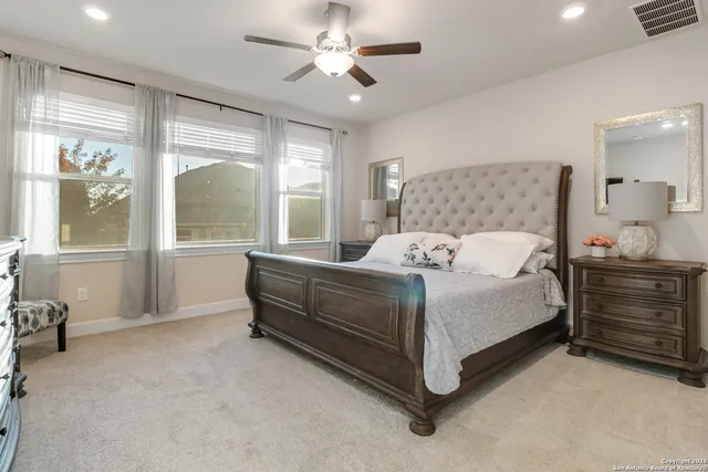 a bedroom with a bed and a large window