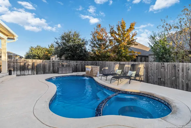 a view of a swimming pool with a patio