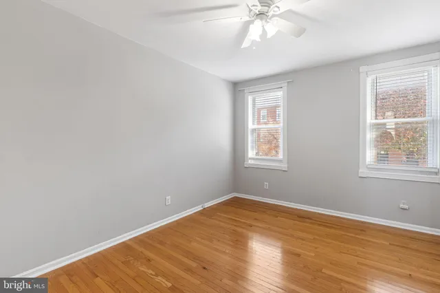 a view of a room with wooden floor and windows