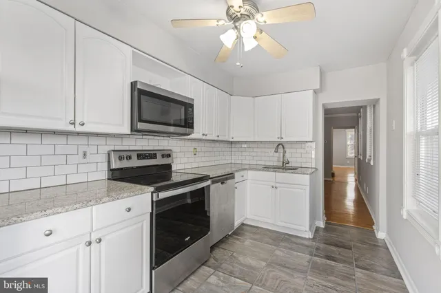 a kitchen with a stove microwave and a sink