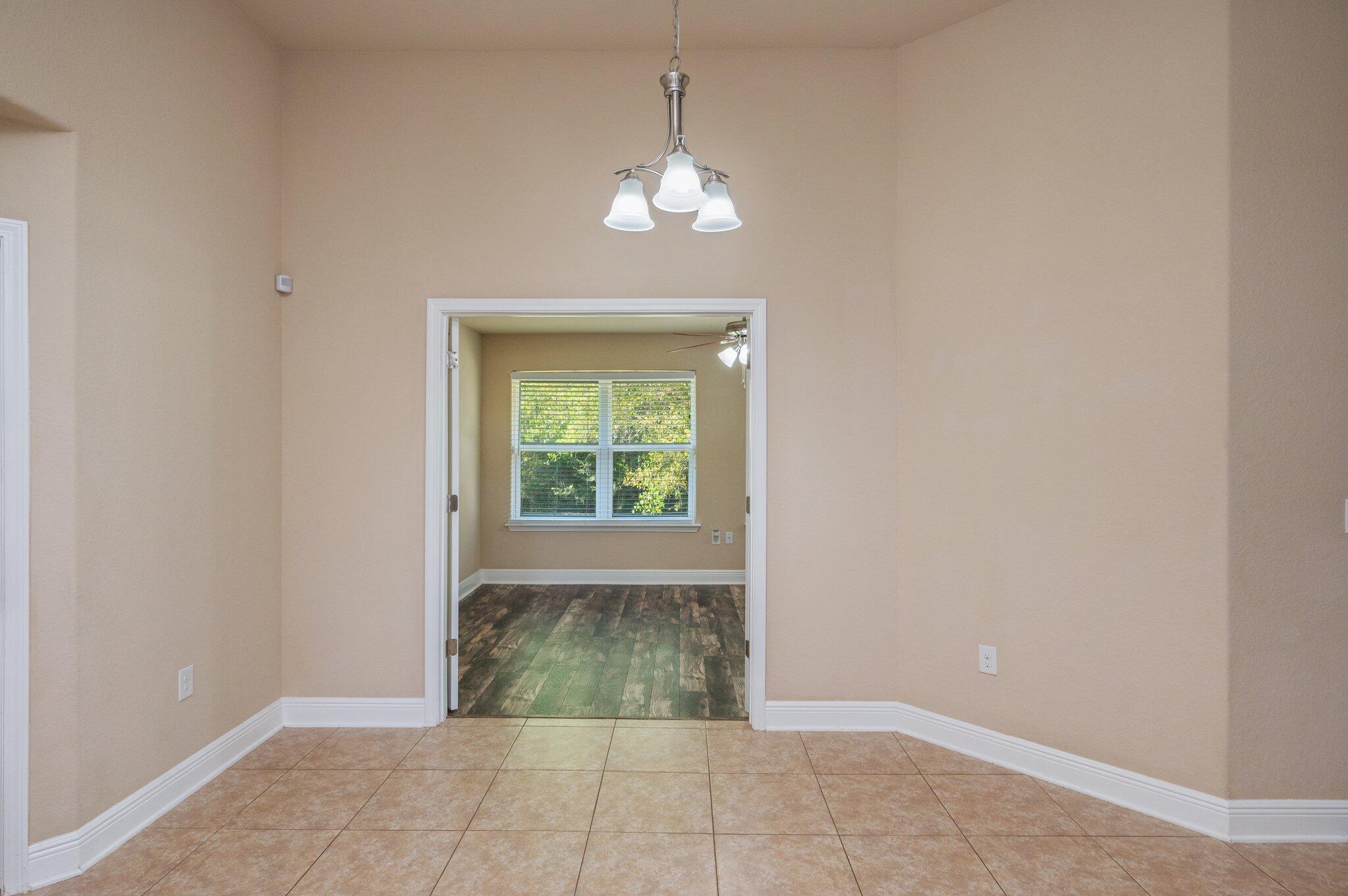 513 Vale Loop Crestview, FL 32536 - Photo 18 of 50 a view of an empty room with window and chandelier fan