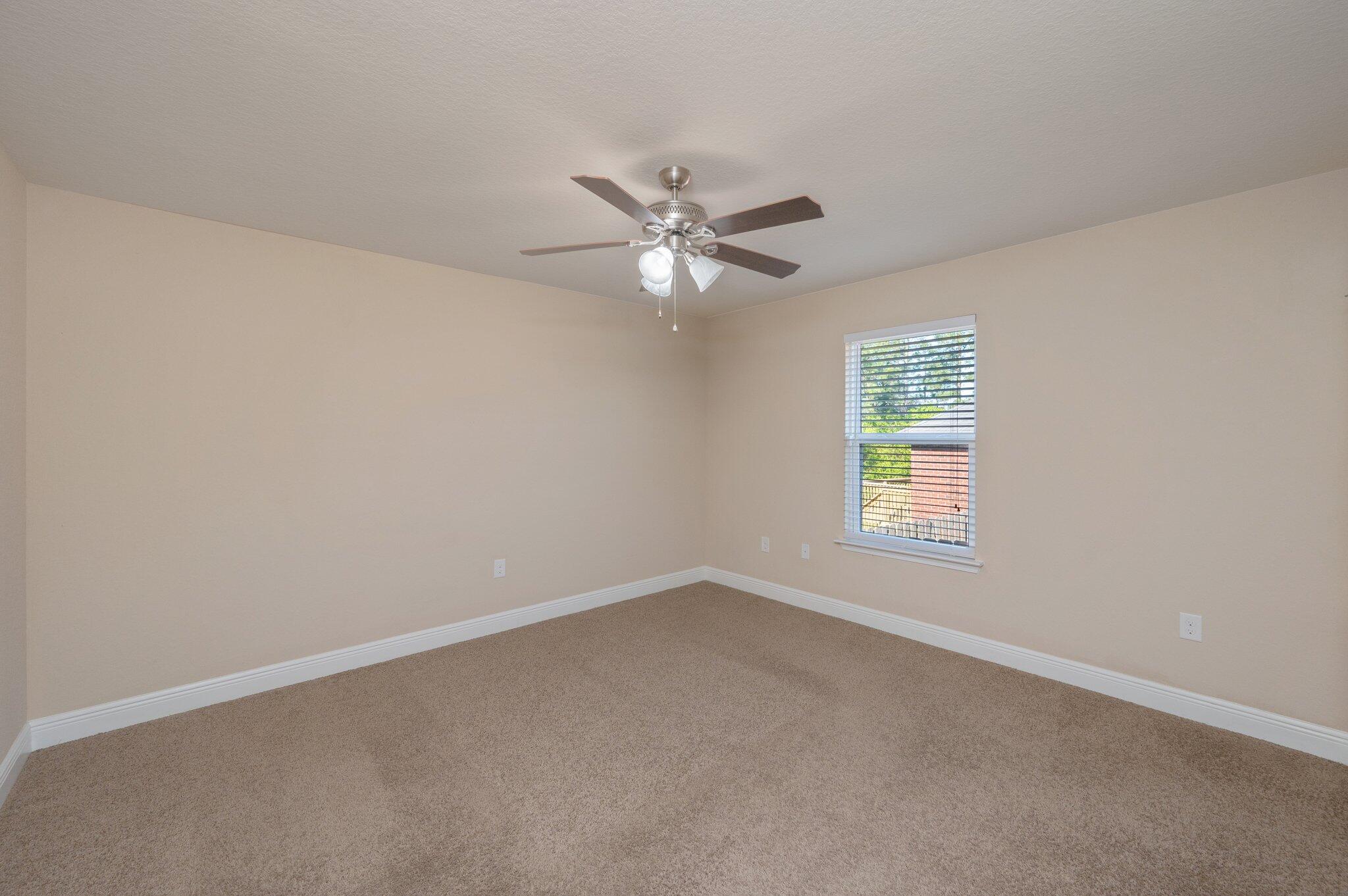 513 Vale Loop Crestview, FL 32536 - Photo 34 of 50 an empty room with a window and a fan