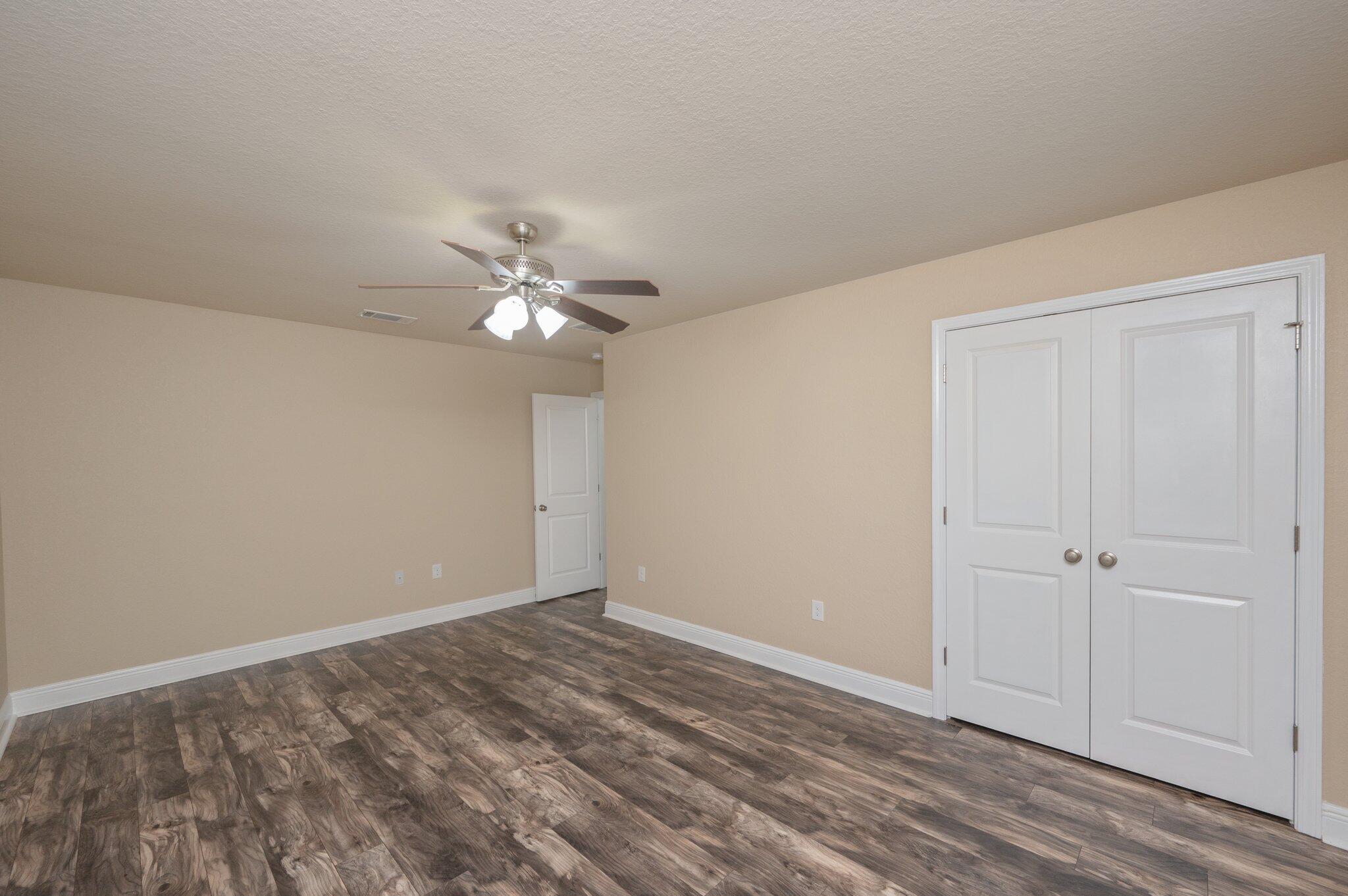 513 Vale Loop Crestview, FL 32536 - Photo 38 of 50 a view of an empty room with wooden floor