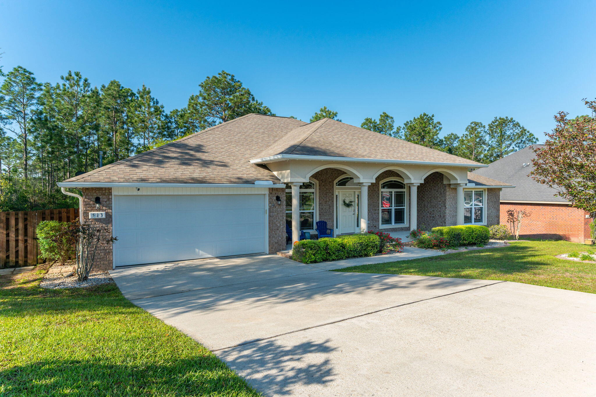 513 Vale Loop Crestview, FL 32536 - Photo 4 of 50 a front view of a house with a yard and garage