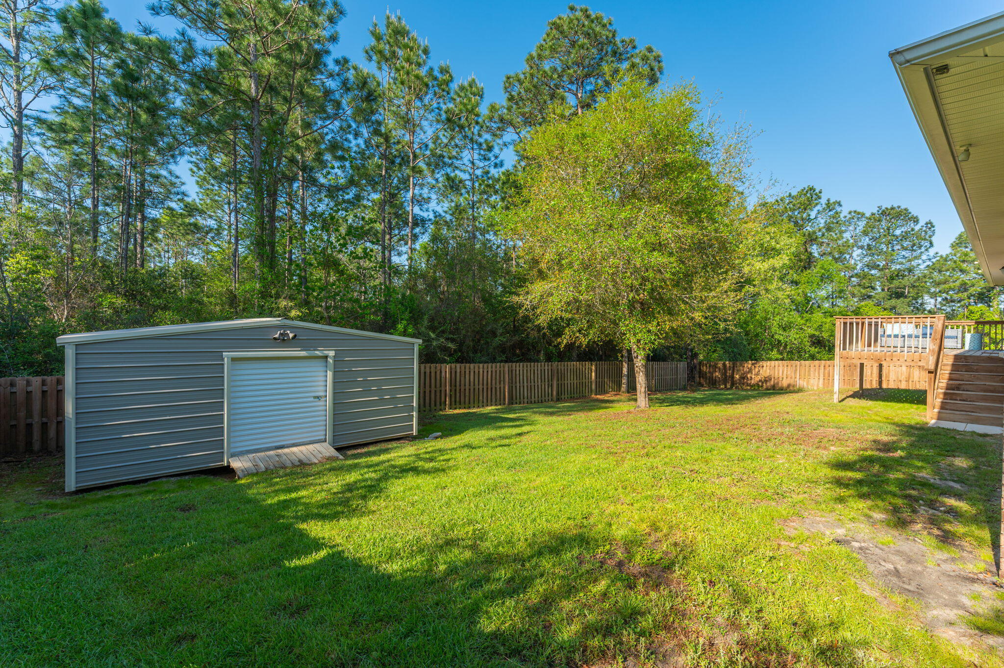 513 Vale Loop Crestview, FL 32536 - Photo 47 of 50 a view of a backyard with a small cabin