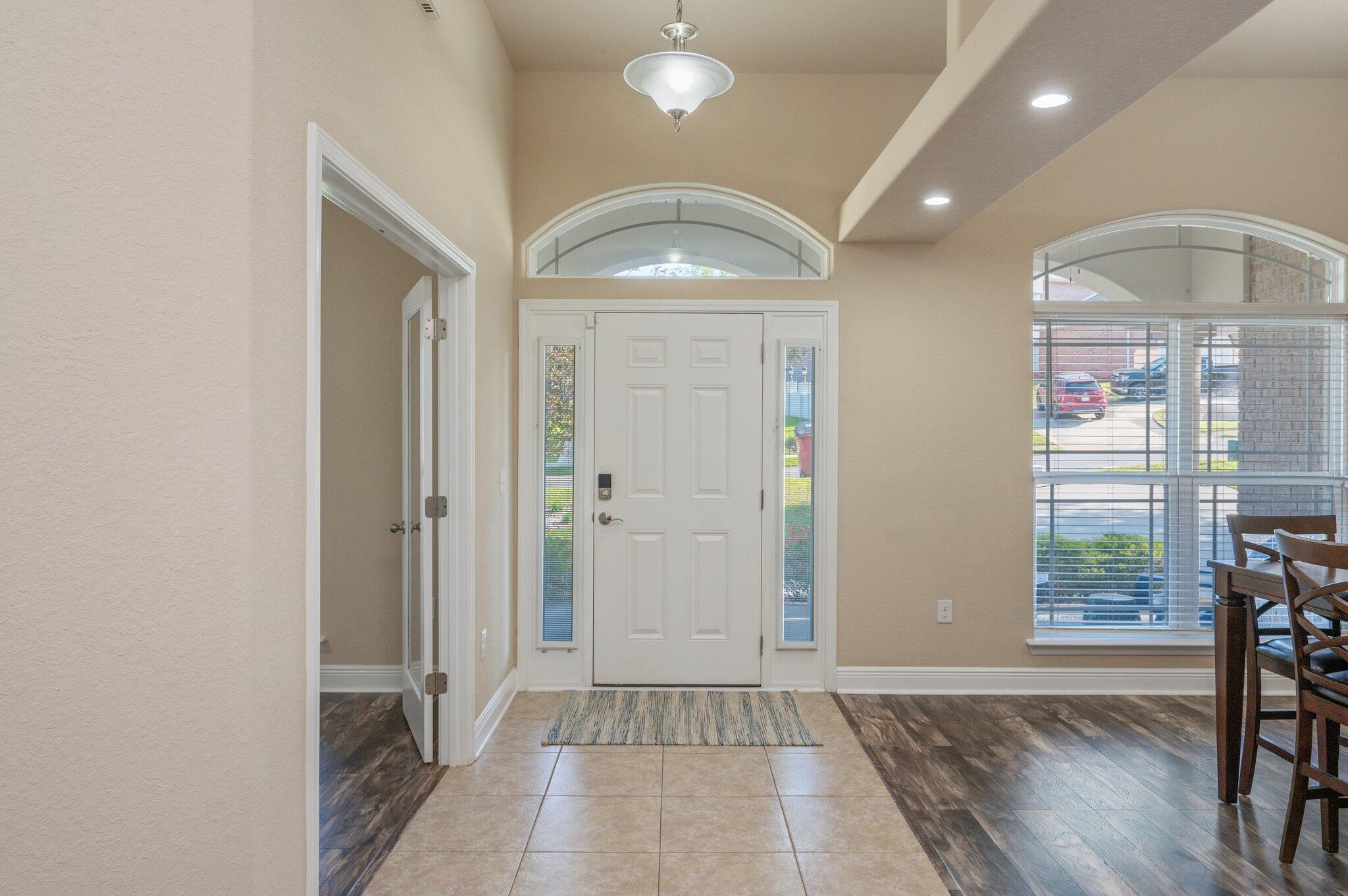 513 Vale Loop Crestview, FL 32536 - Photo 7 of 50 an empty room with wooden floor and windows