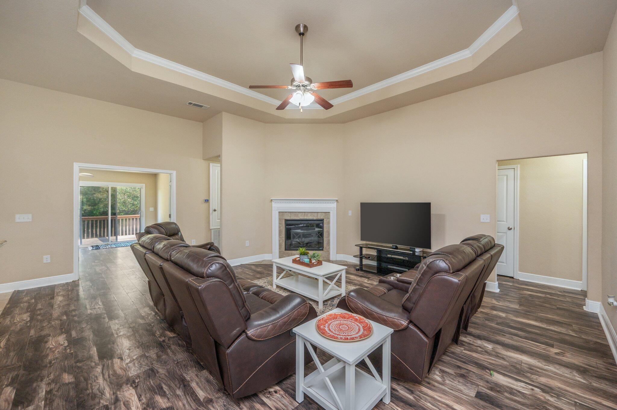 513 Vale Loop Crestview, FL 32536 - Photo 8 of 50 a living room with furniture a fireplace and a flat screen tv