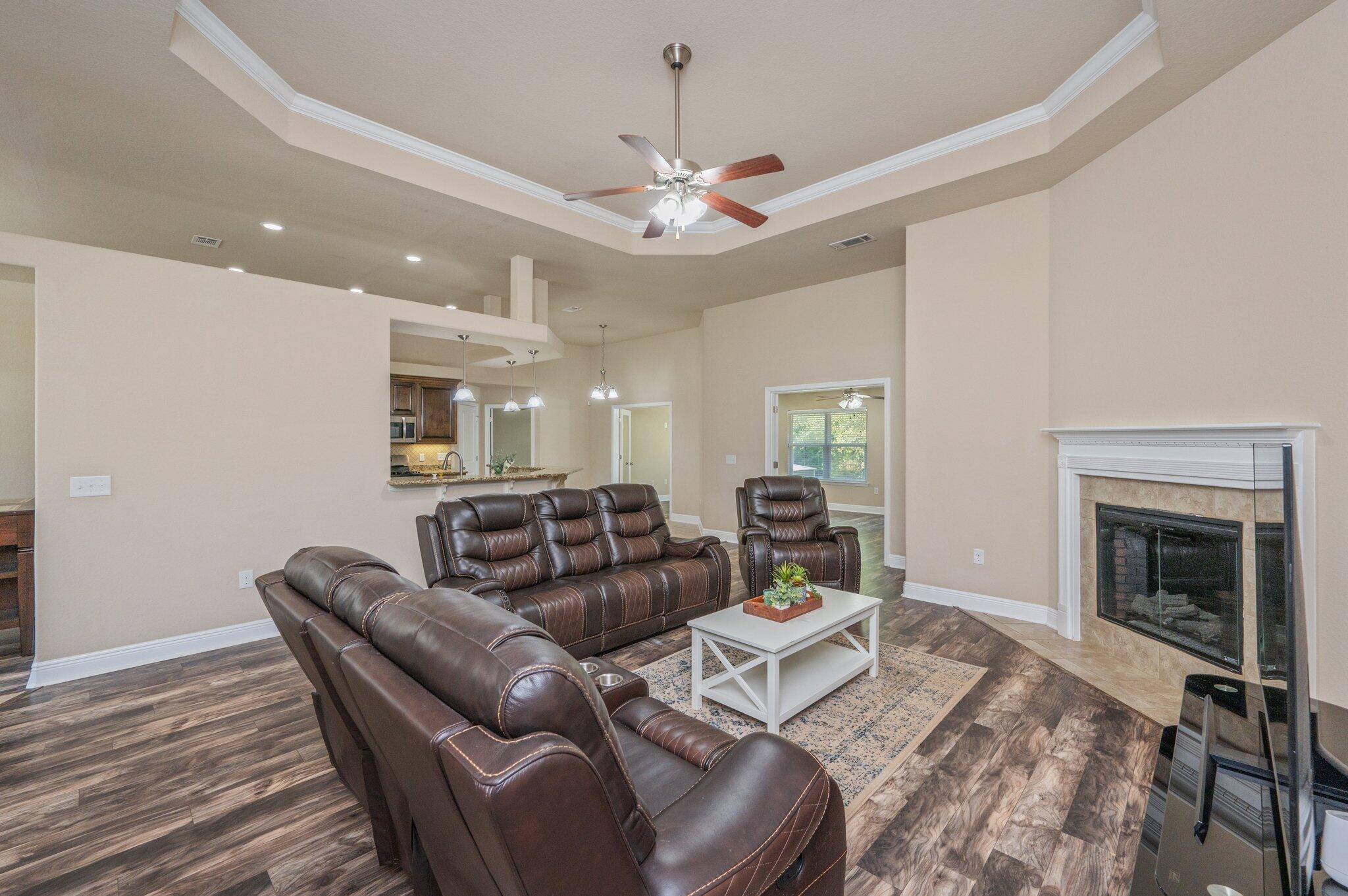 513 Vale Loop Crestview, FL 32536 - Photo 9 of 50 a living room with furniture a chandelier and a fireplace