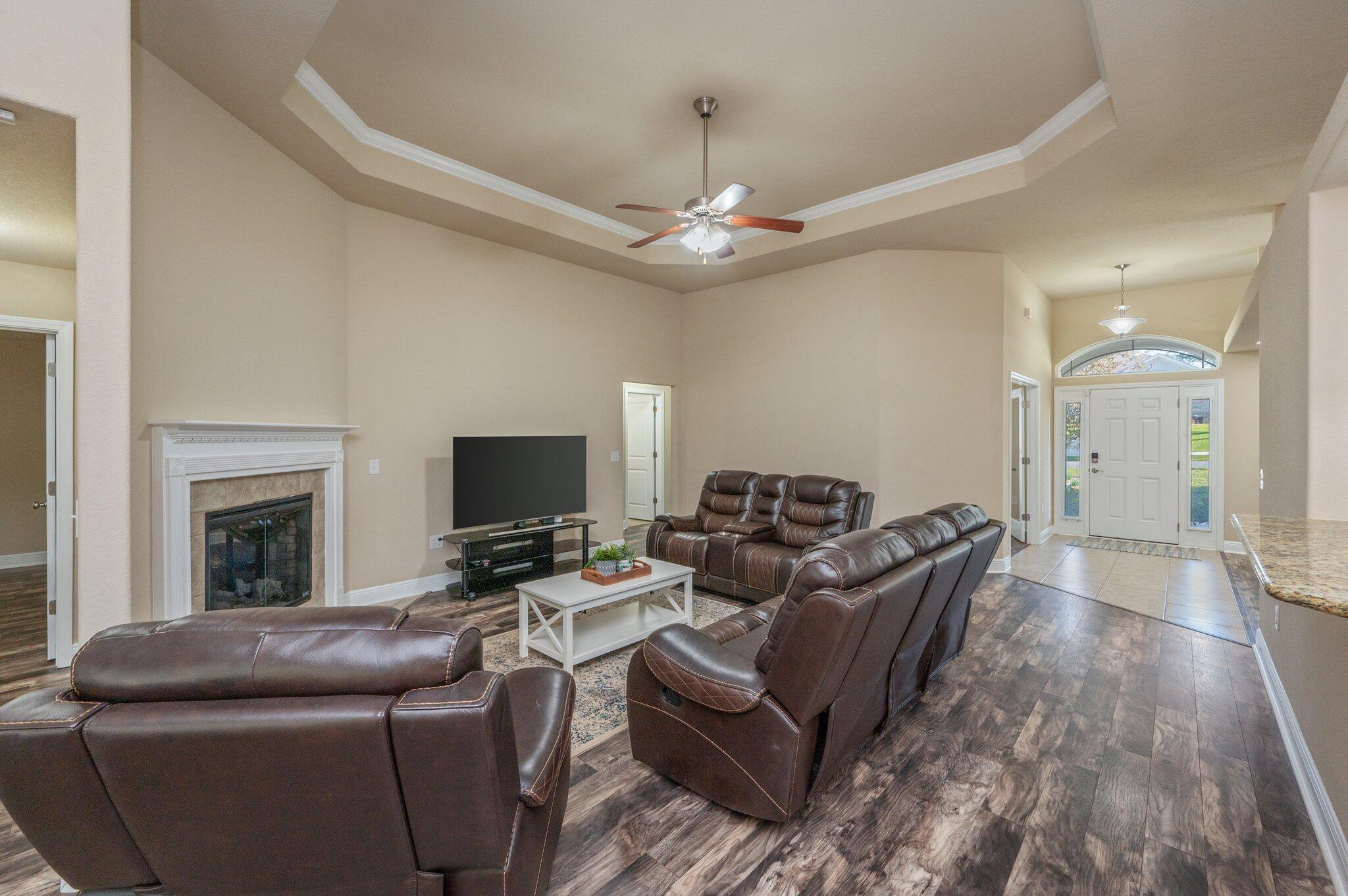 513 Vale Loop Crestview, FL 32536 - Photo 10 of 50 a living room with furniture a fireplace and a flat screen tv