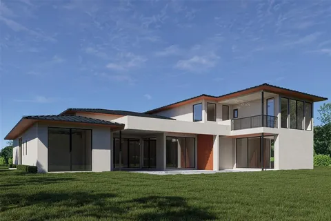 a front view of a house with a garden and yard