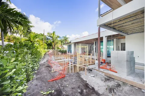 a view of a patio with table and chairs and potted plants