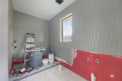 a view of a livingroom with an empty space and a window