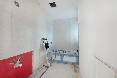 an aerial view of a house with a yard and garden