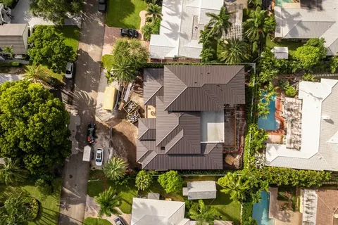 an aerial view of multiple houses with yard