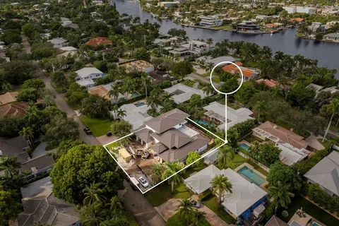 an aerial view of a house with a swimming pool and outdoor seating