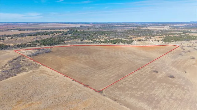 a view of mountain with sunset in background
