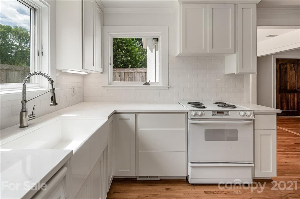 327 Marsh Road Charlotte, NC 28209 - Photo 12 of 48 a kitchen with granite countertop white cabinets and white appliances