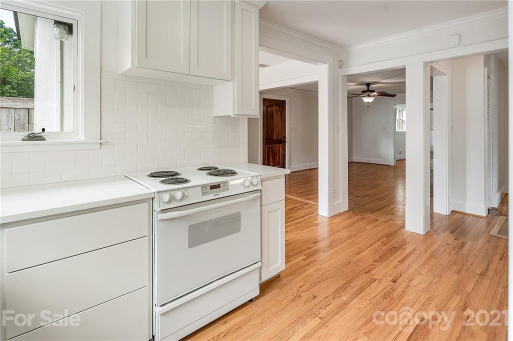 327 Marsh Road Charlotte, NC 28209 - Photo 16 of 48 a kitchen with granite countertop cabinets appliances and a wooden floor